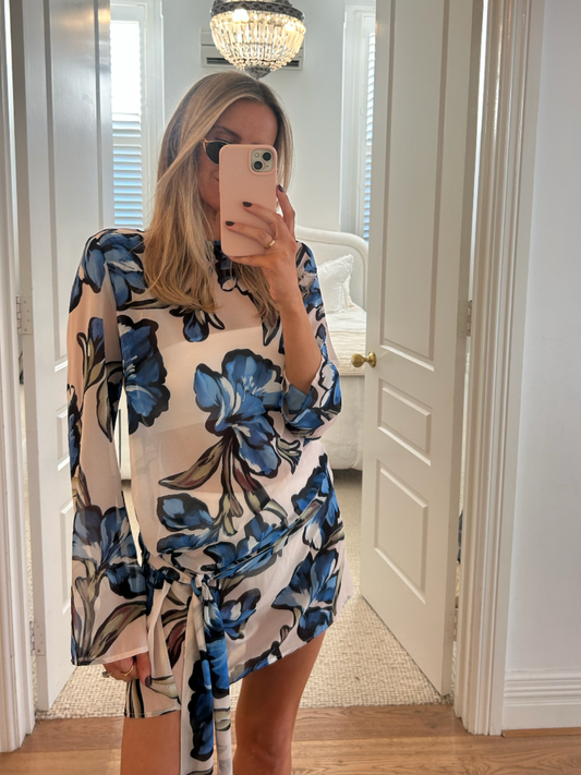 Model Wearing BY NICOLA Elodie Mini Dress in Blue Floral with feminine floral print and mini silhouette
