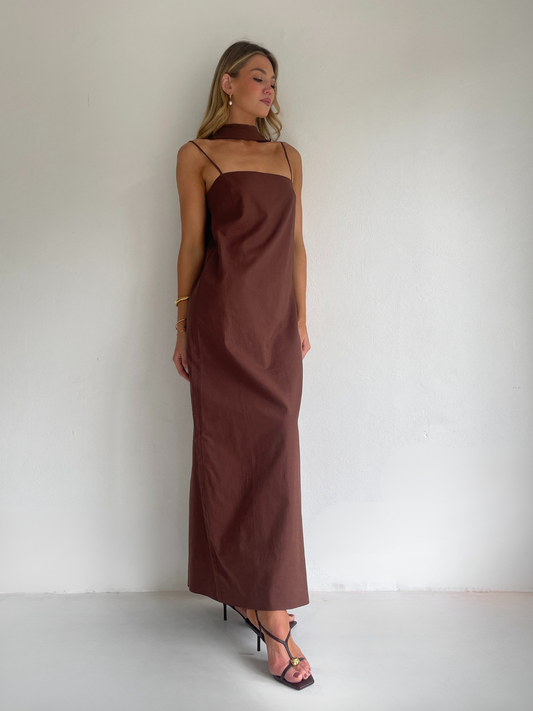 By Nicola Ivy maxi dress in chocolate brown cotton-linen with straight neckline, side slit, column style and chiffon neck tie, ideal for weddings and summer events.