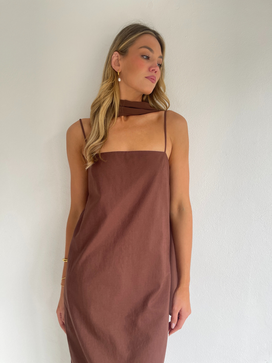 By Nicola Ivy maxi dress in chocolate brown cotton-linen with straight neckline, side slit, column style and chiffon neck tie, ideal for weddings and summer events.