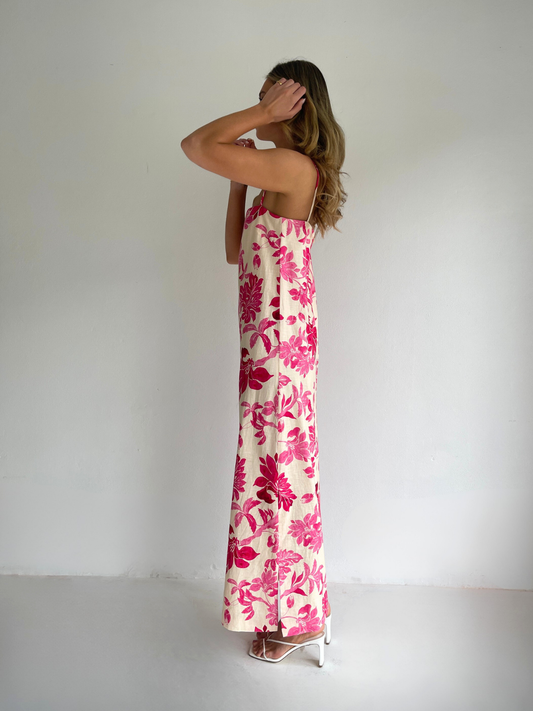 By Nicola Ivy maxi dress in pink floral print with column silhouette, straight neckline and side split, perfect for weddings and summer events.